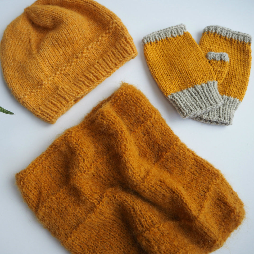 hand knitted hat, hand warmers and cowl in mustard yarn