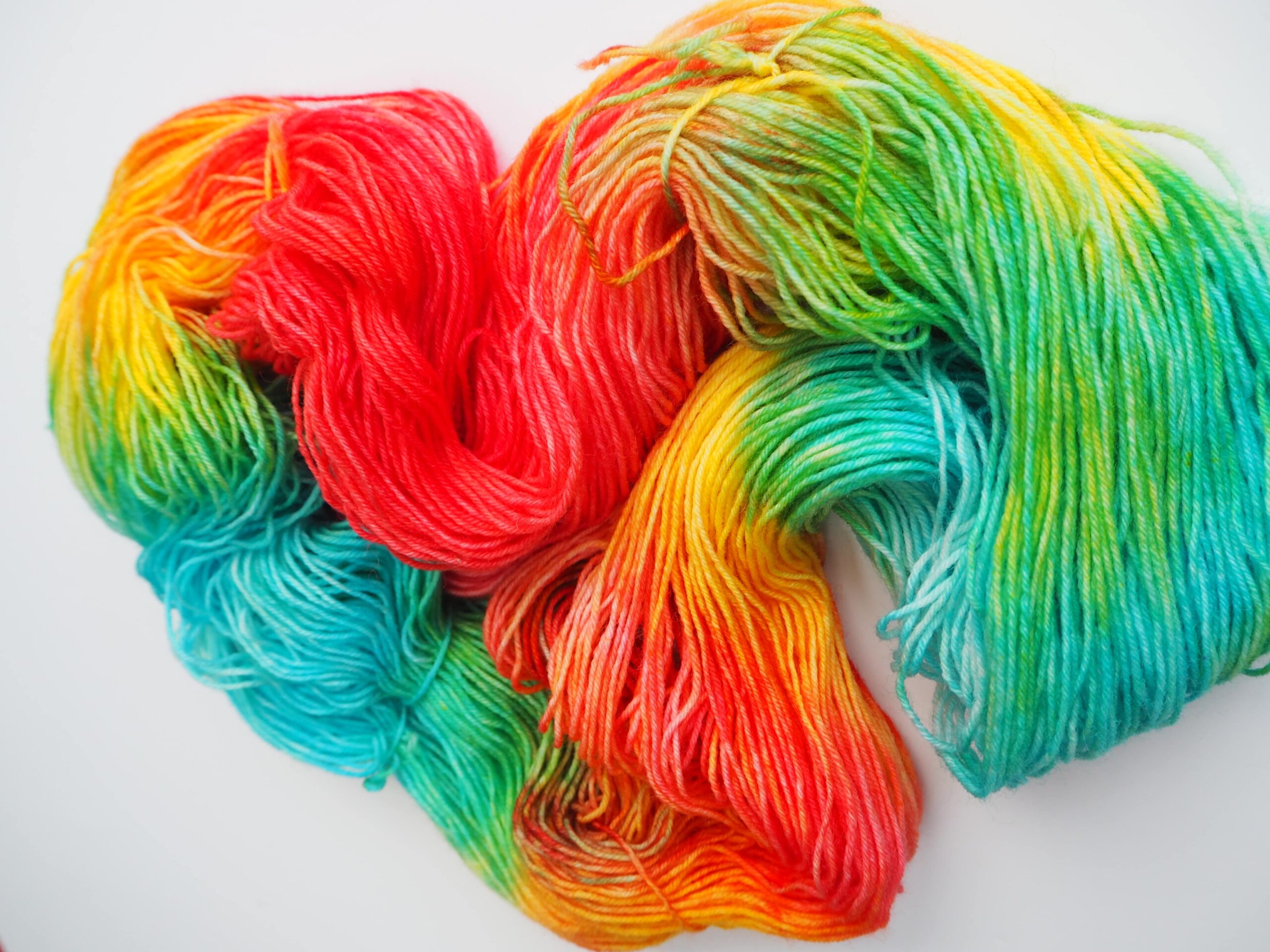 hand dyed yarn in blue, yellow, green and red