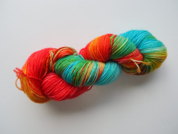 hand dyed yarn skein in blue, yellow, green and red