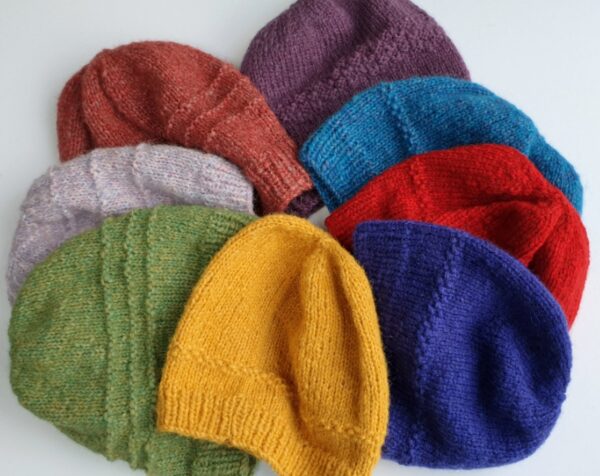 pile of colourful hand knitted hats