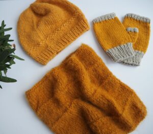 hand knitted hat, fingerless gloves and cowl in mustard yellow yarn